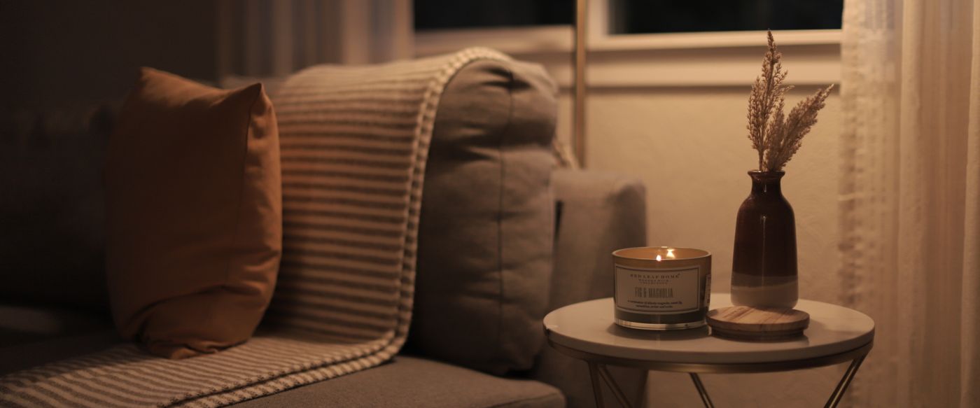 A lit candle in a cosy living room, perfect for aroma candles Australia evenings