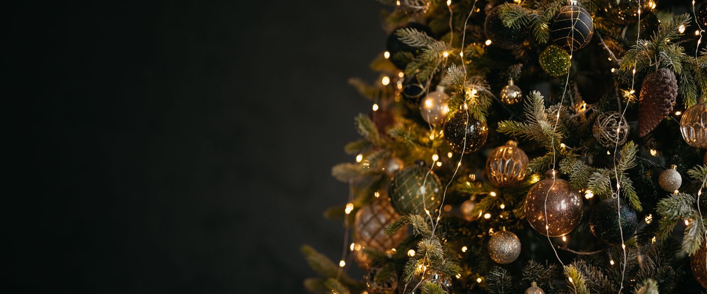 Warm lights on a decorated Christmas tree, a scene for Christmas scented candles