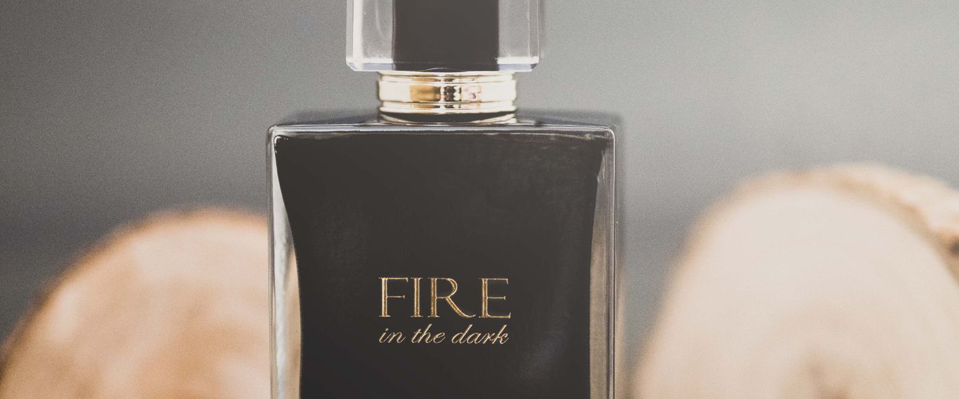 Perfume bottle on rustic wood, a quiet scene about great smelling candles and scent
