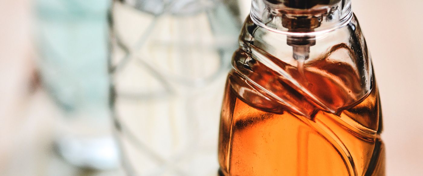 Glass perfume bottles on a wooden surface, a scent wardrobe for scented candles Australia