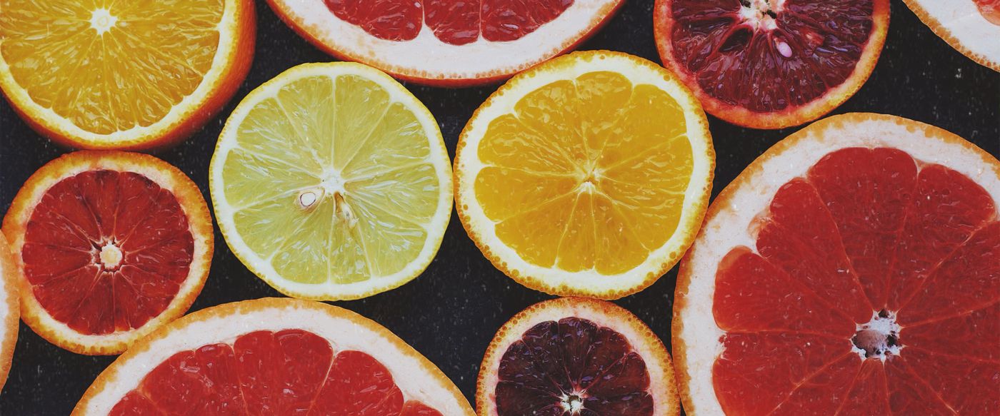 Top view of sliced citrus fruits, the kind of fresh fruit smells studied in fragrance in candles research