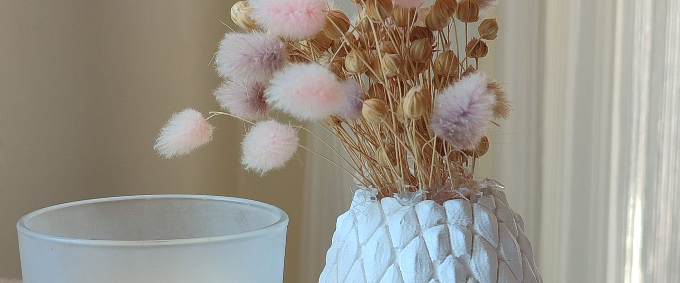 Pastel floral arrangement beside a scented candle, showing scented candles Australia homes can style in spring