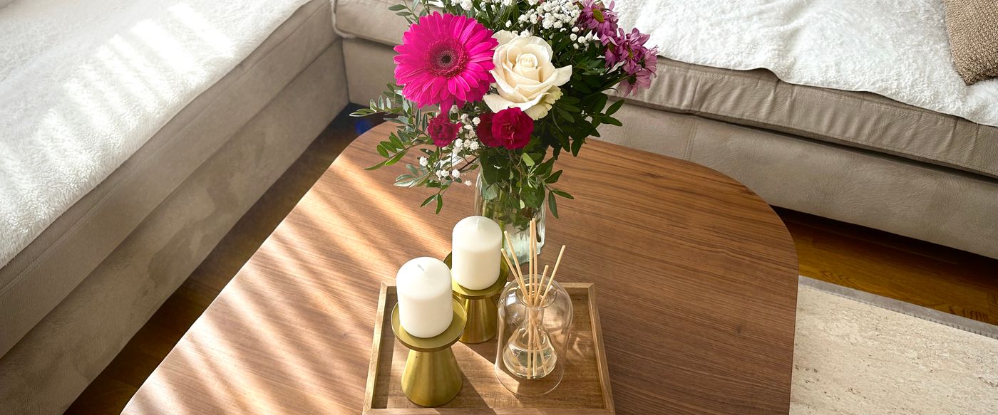 Nicest candles paired with a fresh flower bouquet in a spring living room.
