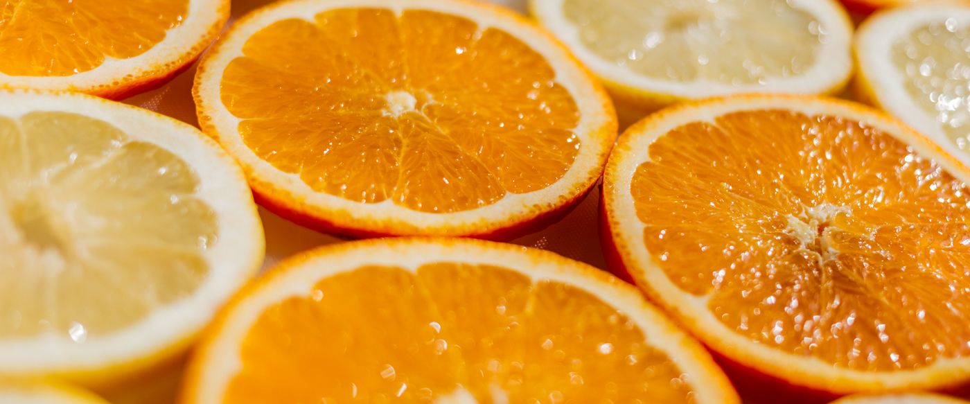 Close-up of bright orange slices, a citrus note used in perfumed candles online