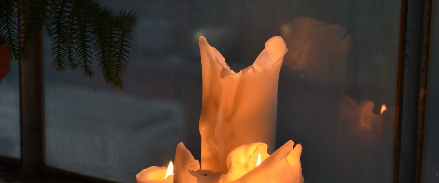 Burning candles on a windowsill at home in the evening, ready for a calm candle fragrance routine