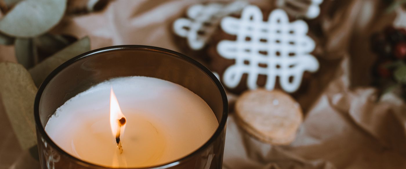 A burning candle with natural decor, a calm evening scene for the best scented candles Australia