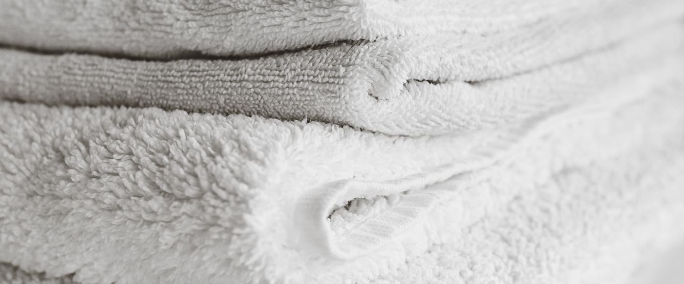 Neatly folded white towels, a clean fresh look for wax melts