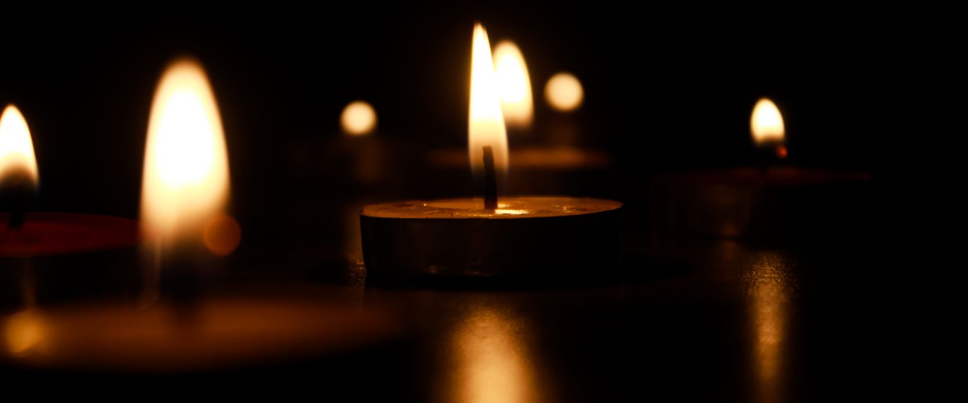 Lit candles glowing warmly in the dark, a calm setting for candle scents Australia loves